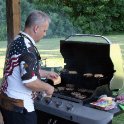 Tom cooks the cheeseburgers